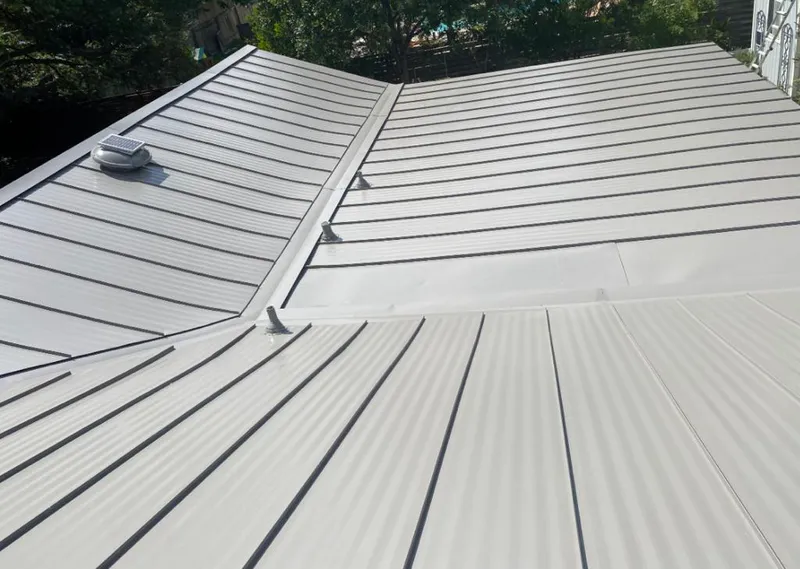 Solar attic fan installed on a metal roof for Roof Ventilation in South Monrovia Island